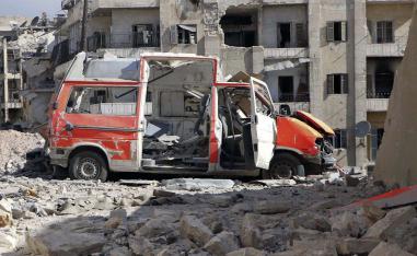 A destroyed ambulance is seen outside the Syrian Civil Defense main center after airstrikes in eastern Aleppo