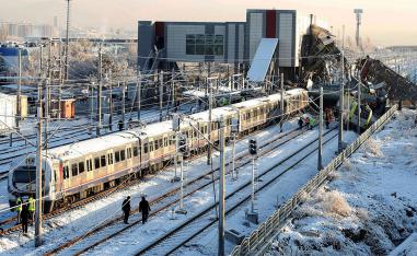 Rescue workers search at the wreckage after a high speed train crash in Ankara