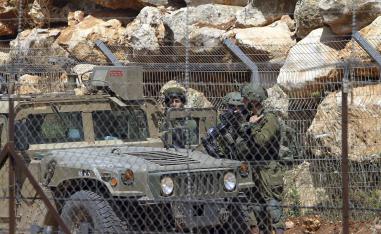 Israeli soldiers patrol the Lebanon-Israel border
