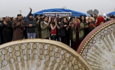 Kurdish demonstrators gather to protest near the border wall separating Turkey from Syria in the western Syrian countryside of Ras al-Ain on December 20, 2018.