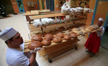 Men with special needs hold bread in the southern city of Tyre, Lebanon December 18, 2018.