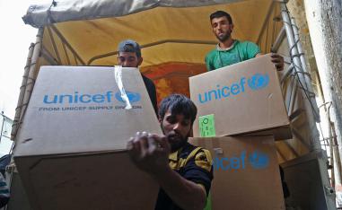 Syrians unload aid packages at al-Nashabia in the rebel-held Eastern Ghouta region