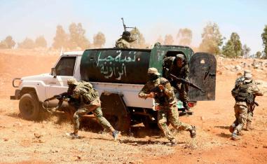 In this file photo taken on August 14, 2018 Syrian fighters attend a mock battle in anticipation of an attack by the regime on Idlib province and the surrounding countryside, during a graduation of new Hayat Tahrir al-Sham (HTS) members at a camp in the countryside of the northern Idlib province.