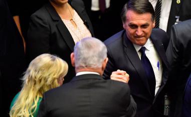 Brazil's newly sworn-in President Jair Bolsonaro (R) greets Israel's Prime Minister Benjamin Netanyahu (C), during his inauguration ceremony, at the Congress in Brasilia on January 1, 2019.