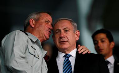 Israel's Prime Minister Benjamin Netanyahu (R) and Israel's armed forces chief Major-General Benny Gantz speak during the opening ceremony of the 19th Maccabiah Games at Teddy Stadium in occupied Jerusalem July 18, 2013.