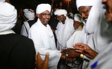 Sudanese President Omar al-Bashir shakes hands with Sufi Muslim clerics at the presidential palace in the capital Khartoum on January 3, 2019.