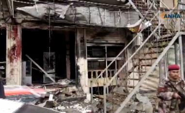 An image grab taken from a video published by Hawar News Agency (ANHA) on January 16, 2019, shows an unidentified member of security forces at the scene of a suicide attack in the northern Syrian town of Manbij.