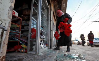 Syrians check the site of a suicide attack targeting US-led coalition forces in the flashpoint northern Syrian city of Manbij which killed four US serviceman the previous day on January 17, 2019.