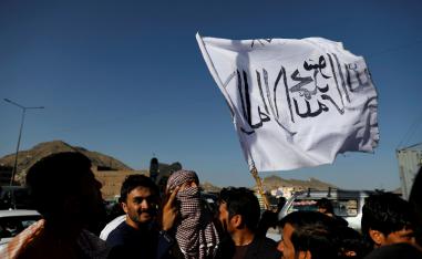 A member of the Taliban holds a flag in Kabul, Afghanistan June 16, 2018.