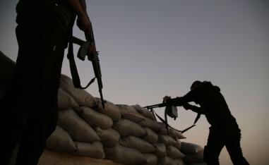 Turkish-backed Syrian fighters take up an armed position with sandbags along the frontline with SDF forces near the village of Kiridiyah, about 30 kilometres west of the northern town of Manbij, on January 15, 2019.