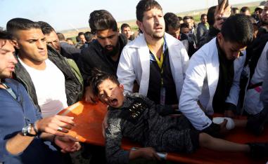 A wounded Palestinian boy reacts as he is evacuated during a protest at the Israel-Gaza fence, in the southern Gaza Strip January 25, 2019. 