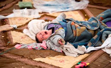 A baby cries at the Internally Displaced Persons (IDP) camp of al-Hol in al-Hasakeh governorate in northeastern Syria on February 6, 2019.