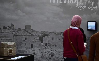A woman visits the exhibition titled "Cultural Landscape of Syria - Preservation and Archiving in Times of War" at the Museum of Islamic Art in the Pergamon Museum on February 27, 2019 in Berlin.