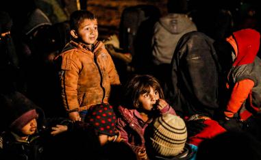 Women and children evacuated from the Islamic State (IS) group's embattled holdout of Baghouz wait in a zone held by the US-backed Syrian Democratic Forces (SDF) during an operation to expel IS jihadists from the area, in the eastern Syrian province of Deir Ezzor, on February 25, 2019.