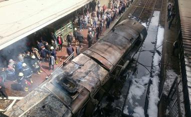 Burnt out wagons sit on the railway tracks after a fire caused deaths and injuries at the main train station in Cairo