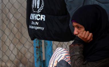 A Syrian displaced girl sits by a fence inside the Internallly Displaced Persons (IDP) camp of al-Hol in al-Hasakeh governorate in northeastern Syria on December 8, 2018.