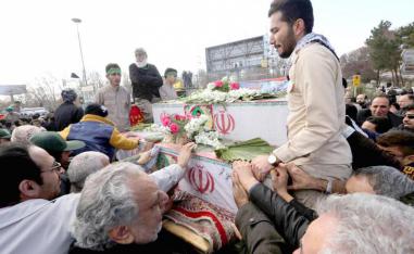 Iranian mourners gather around the coffins of members of Islamic Revolutionary Guard Corps who were killed February 13 in a suicide attack, during their funeral in Isfahan, February 16
