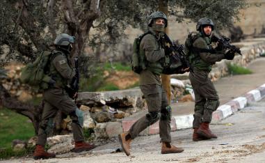  Israeli forces walk during a raid in Ramallah in the Israeli-occupied West Bank December 13, 2018.