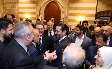Lebanese Prime Minister Saad Hariri (C) stands amongst supporters after a press conference during which he announced the formation of a new national unity government following months of wrangling between rival groups, at Baabda Palace.