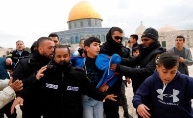 Israeli policemen detain a young Palestinian demonstrator during clashes, after protesters tried to break the lock on a gate at the Al Aqsa mosque compound in Jerusalem's Old City on February 18, 2019, after it was closed by Israeli police.