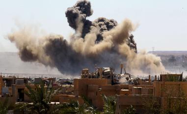 Smoke rises from the last besieged neighborhood in the village of Baghouz