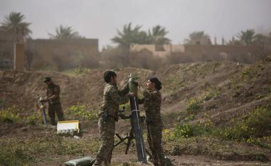 U.S.-backed Syrian Democratic Forces (SDF) soldiers prepare to fire mortars at Islamic State militant positions in Baghouz, Syria, Wednesday, March 13, 2019.
