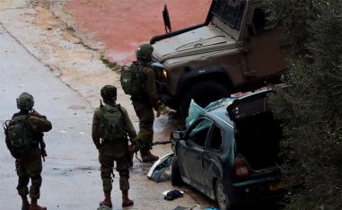 Israeli forces stand at the scene of the incident near Ramallah