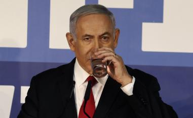 Israeli Prime Minister Benjamin Netanyahu drinks water as he delivers a statement to the press on February 28, 2019, at his residency in occupied Jerusalem.