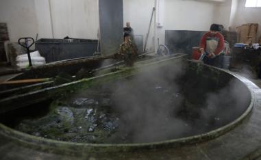 Syrian workers make olive soap in a factory on the outskirts of Aleppo on February 10, 2019.