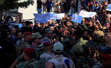 Angry relatives of victims the sunken ferry blocked a road where Iraq's presidential and Mosul's Governor convoy was passing, chanting "no to corruption" and pelting the provincial governor's car with stones in protest in Mosul, Iraq, Friday, March 22, 2019.