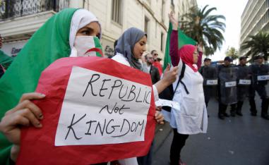 A demonstrator carries a sign as teachers and students take part in a protest demanding immediate political change in Algiers, Algeria March 13, 2019. 