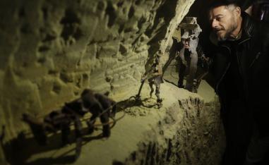 Lebanese Artist Charles Nassar inpsects of his sculptures made out of artilley shrapnels in the village of Remhala, South of Beirut.