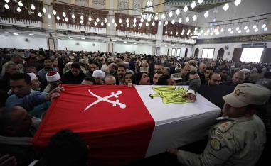 Mourners and members of security forces carry a coffin containing the body of Egyptian military officer Abdulrahman Ali Mohammed who was killed in a clash with militants in North Sinai