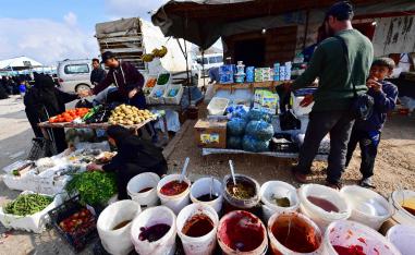 Street vendors sell pickles and vegetables on March 28, 2019 in the souk or market of Al-Hol camp for displaced people in northeastern Syria, which currently brims with more than 70,000 people, even though it was only designed to accommodate a seventh of that number.