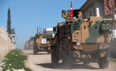 A column of armoured Turkish military vehicles drives on a patrol along a road in the de-militarised zone in the western countryside of Syria's Aleppo province near the town of Al-Eis on March 8, 2019.