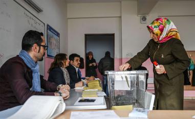A woman casts her vote at a polling station in Istanbul 