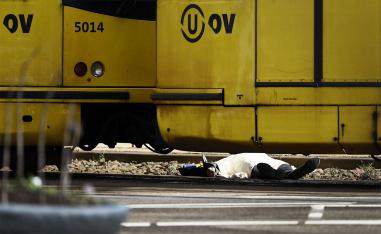 A body lying on the ground is covered near a tram at the 24 Oktoberplace in Utrecht