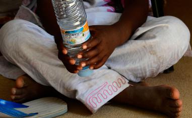 A picture shows the feet and hands of the daughter of Zahra (not her real name) in the office of the president of the Association of Women Heads of Family (AFCF) in Nouakchott on January 28, 2019.