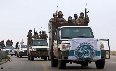 HTS fighters driving their vehicles during a military drill in northern Syria