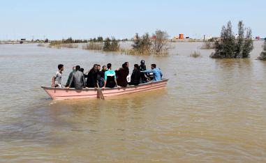 People are seen on a boat after a flooding in Golestan province, Iran, March 24, 2019.