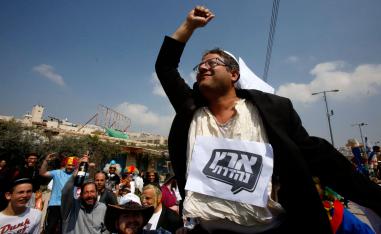 Jewish settlers carry Itamar Ben-Gvir, Jewish Power party leader, as they celebrate the Jewish Purim holiday at al-Shuhada street in the occupied Palestinian town of Hebron on March 21, 2019.