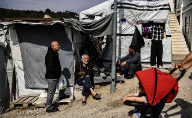An elderly man sits inside the official refugee camp of Moria on Lesbos Island