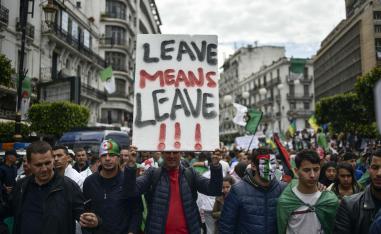 Algerians raise a placard as they take part in an anti-government demonstration, on April 5, 2019 in the capital Algiers. 
