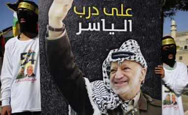 Supporter of the Palestinian Fatah movement carry a placard in the occupied West Bank city of Nablus