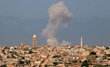 Smoke billows after reported shelling on the Syrian village of Kfar Nabouda in the northern countryside of Hama province