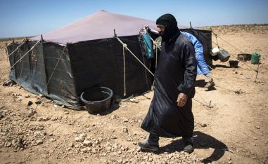 A Nomadic herder walks near tents in the southern Moroccan Tiznit province in the region of Souss-Massa