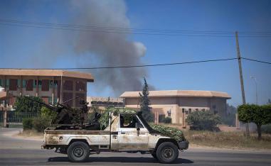 Smoke rises above buildings in Espiaa, south of Tripoli