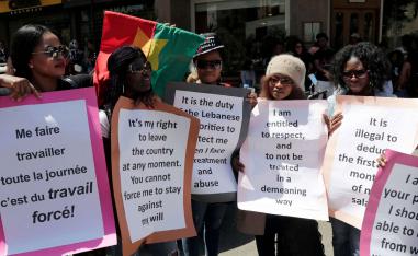 Migrant domestic workers carry placards during a protest in the Lebanese capital Beirut