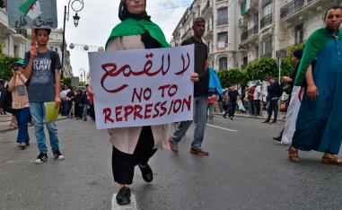 An Algerian protester carries a placard during an anti-government demonstration in the capital Algiers