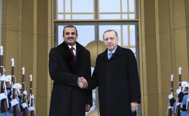 Turkey's President Recep Tayyip Erdogan, right, shakes hands with Qatar's Sheikh Tamim bin Hamad Al Thani